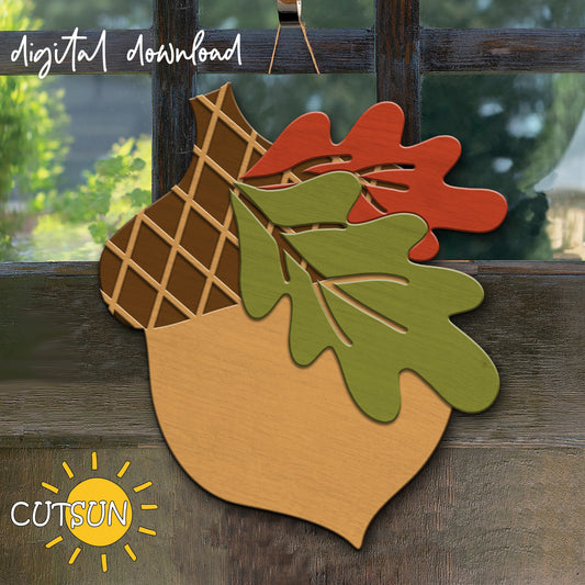 A digital download of a fall-themed door hanger featuring an acorn with oak leaves, displayed on a door in a rustic setting.
