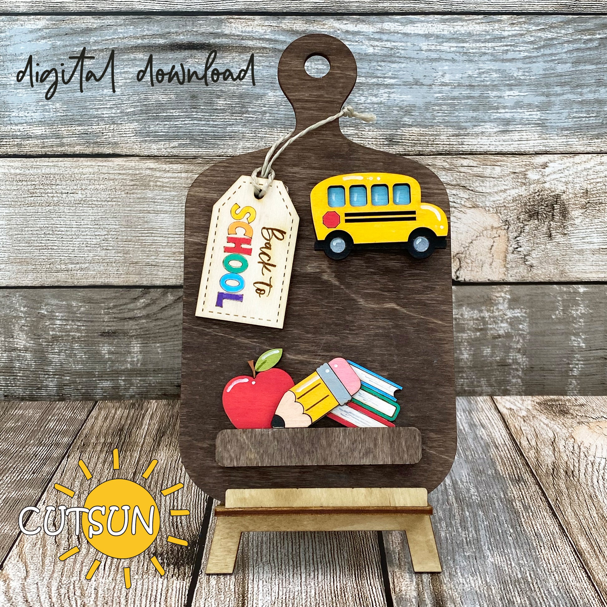 Digital download for a faux cutting board shelf decor featuring a Back to school add on with a School bus, an apple, pencil, stack of books, and a tag with the text 'Back to school'.