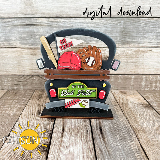 Digital download for a decorative farmhouse truck filled with baseball items: a bat, a flag with the text 'Go team', a baseball cap, a baseball glove, and a plaque with the text 'At the Ball field"