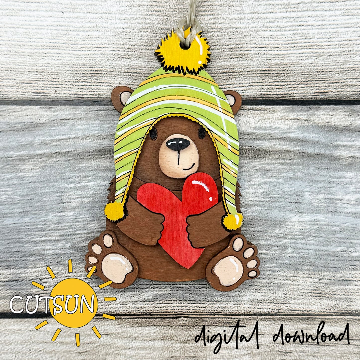 Layered bear with heart ornament SVG file for laser cutting, featuring a winter hat and red heart, perfect for Valentine’s crafts and gifts.