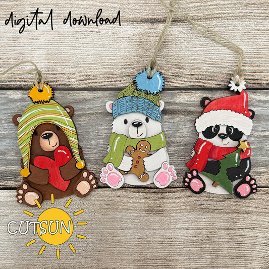 Three Christmas-themed animal ornaments with colorful hats and scarves on a wooden background, featuring the brand 'CUTSUN'.