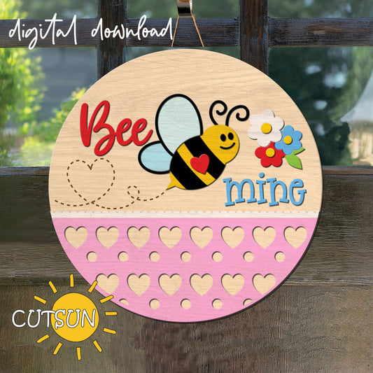 Circular wooden sign with a bee and flowers design, text 'Bee mine', and heart shapes on a wooden background.