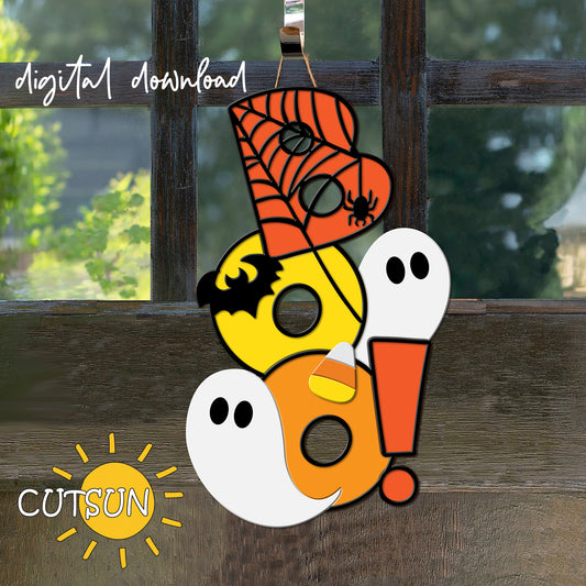 A digital illustration of a Halloween-themed door hanger sign featuring a spider web background, with cute ghosts, a bat, candy corn, and the word 'BOO!' in a playful spiderweb font, displayed on a door.