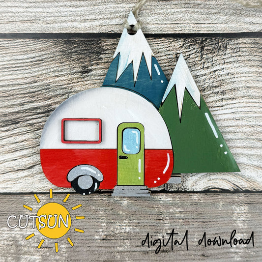 Layered camper ornament SVG featuring a red and white retro trailer with mountains, designed for laser cutting and Christmas décor.
