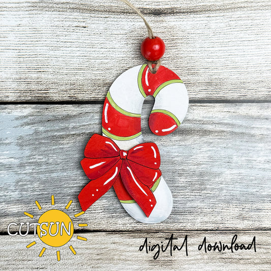 Decorative candy cane ornament with a bow on a wooden surface, featuring the CUTSUN brand.