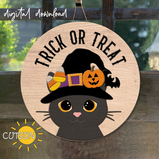 A digital door hanger featuring a round wooden background with a central image of a cartoon cat wearing a witch's hat, surrounded by decorative elements like candy corns, a pumpkin, and a bat, with the text 'TRICK OR TREAT' at the top.