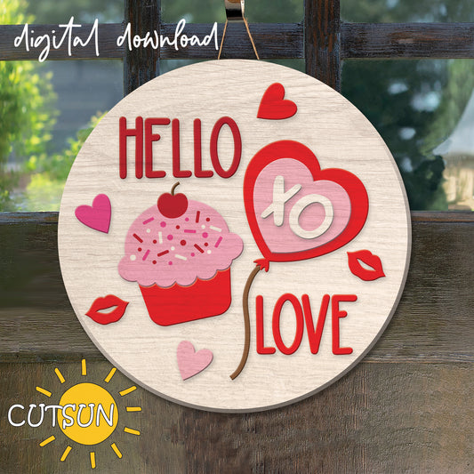 Digital download for a round Valentine's day door hanger featuring a cupcake with a cherry on top, a heart-shaped balloon, hearts and lips, and the text 'Hello Love'.