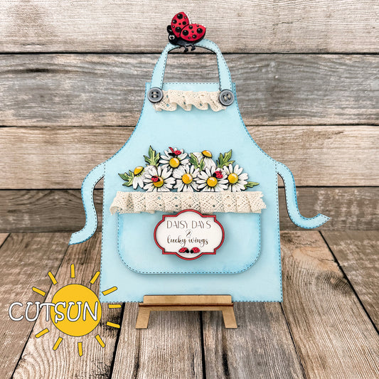 Laser-cut daisy and ladybug add-on for apron shelf sitter, featuring floral pocket filler and cute summer details.