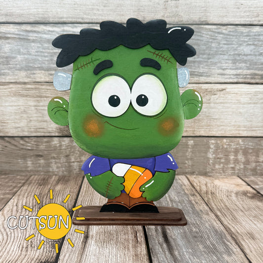 Cute Frankenstein shelf sitter SVG holding a candy corn – Halloween laser cut design for fall shelf decor