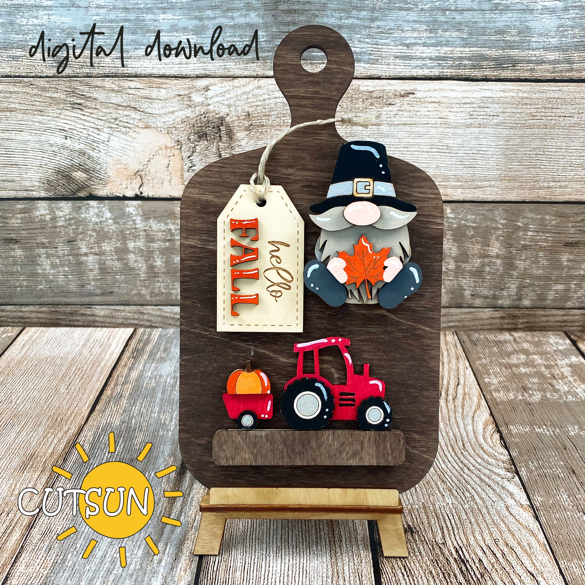 Digital download for a faux cutting board shelf sitter featuring a Pilgrim gnome, a tractor with a pumpkin and a tag with the text Hello Fall.