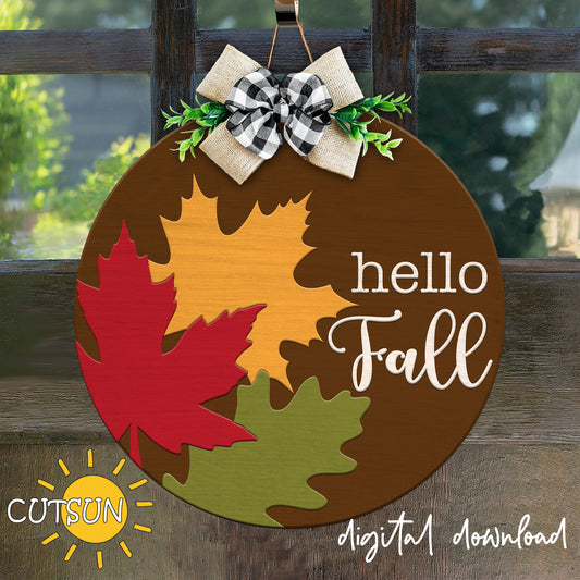 A digital image of a fall-themed door hanger with leaf shapes in red, brown, and green, and the text 'Hello Fall' in a circular design.