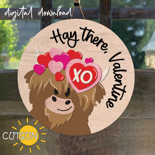 A digital illustration of a Valentine's Day themed door hanger featuring a cartoonish highland cow with hearts and the text 'Hay there, Valentine'. The background is outlined in a warm beige color, and there is a 'Digital Download' label at the top.