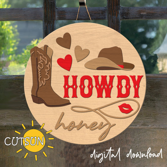 Wooden plaque with cowboy boot, hat, and 'HOWDY honey' text on a wooden background