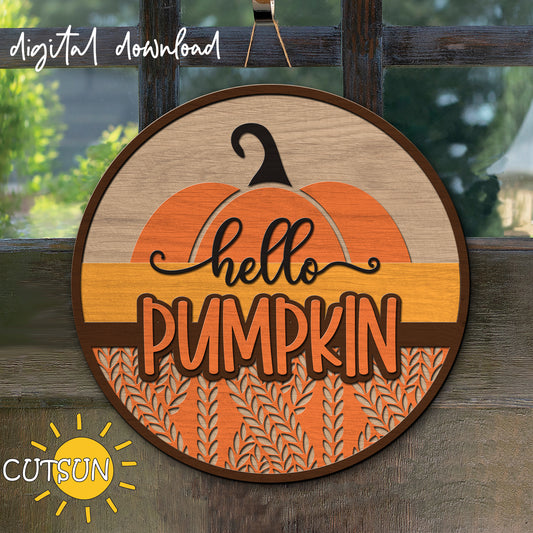 A digital download of a 'Hello Pumpkin' sign with a cable knit texture, displayed as a round shape with a wooden background, pumpkin in the center and text in orange.