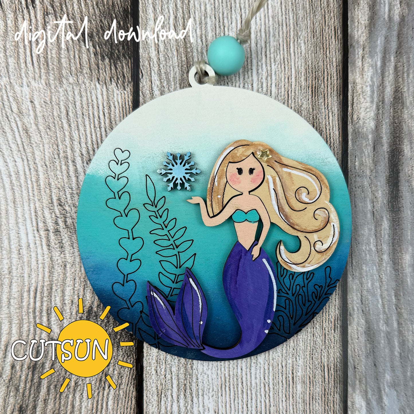 Mermaid Christmas ornament SVG design with snowflake and seaweed, layered laser cut file for ocean-inspired holiday décor.