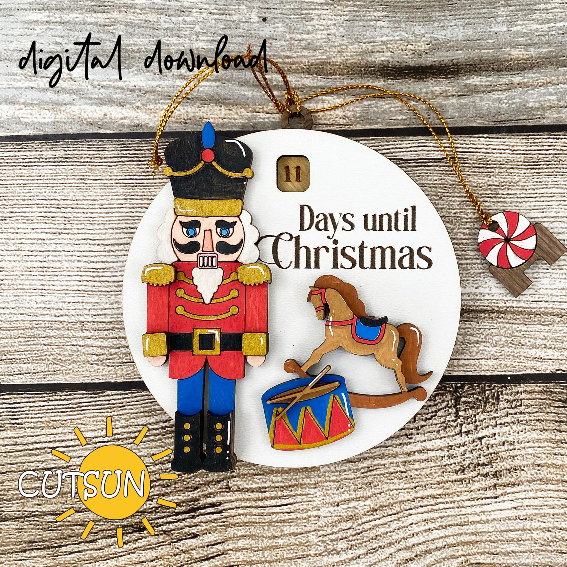 A digital illustration of a Christmas ornament featuring a nutcracker, a rocking horse, and a drum with drumsticks, with the text 'Countdown to Christmas' and '10 days until'.