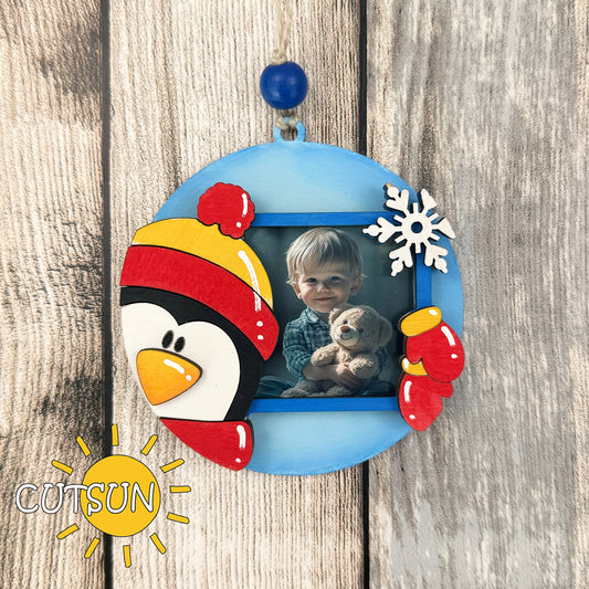 Penguin-shaped Christmas photo ornament with mittens and snowflake – SVG file for laser cutting