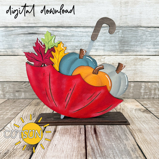 A vibrant digital download illustration of an upside down umbrella shelf sitter, overflowed with layered pumpkins and autumn leaves, on a wooden surface with the text 'CUTSUN' and 'digital download' indicating the brand and file type.