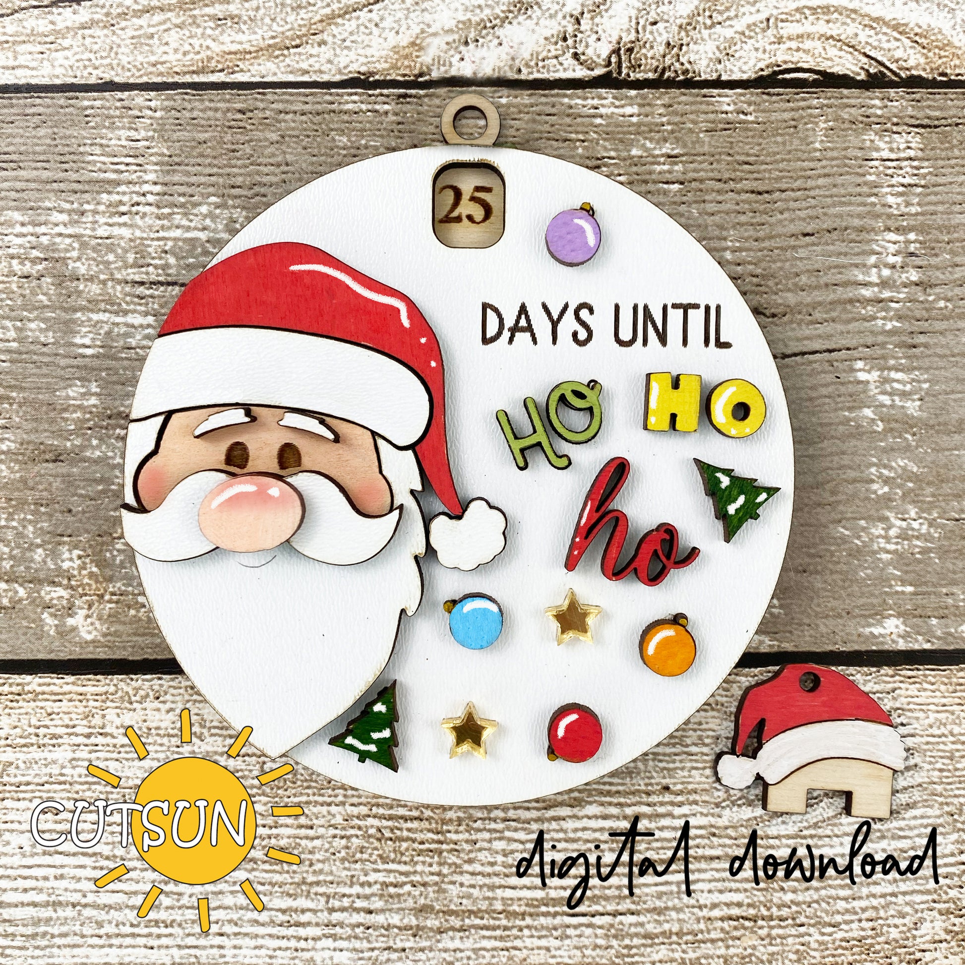 A digital illustration of a circular Christmas ornament with Santa Claus and a 'Days until Ho Ho Ho' message, along with decorative elements like stars and Christmas trees.