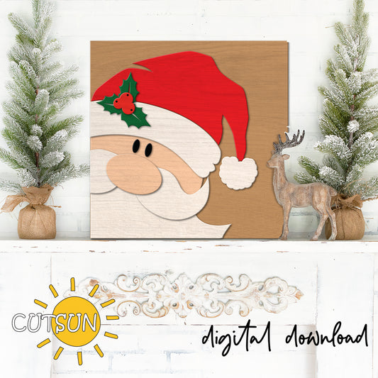 Wooden Christmas decoration with Santa Claus face, holly leaves, and berries on a wooden background.