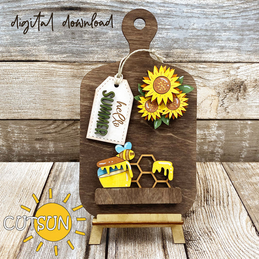 Digital download for a faux cutting board shelf sitter featuring a sunflowers bouquet, a honey pot, hexagons pattern, a bee and a tag with the text 'hello Summer'.