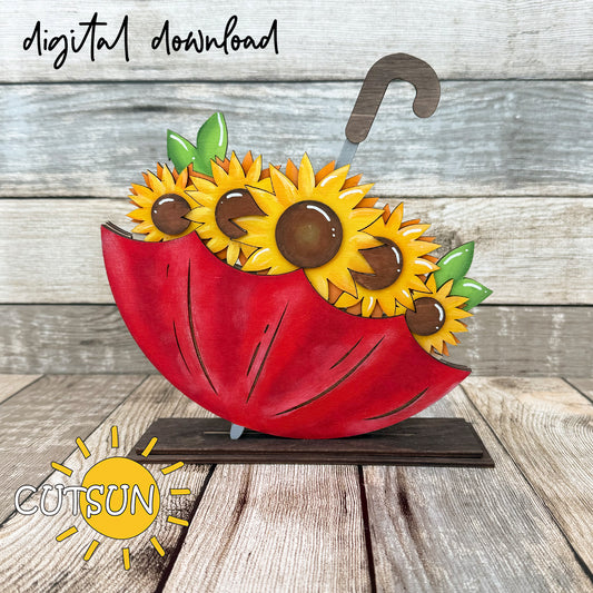 A digital download illustration of sunflowers arranged on an umbrella-shaped base, with a 'CUTSUN' logo and a sun icon indicating the design is for laser cutting.