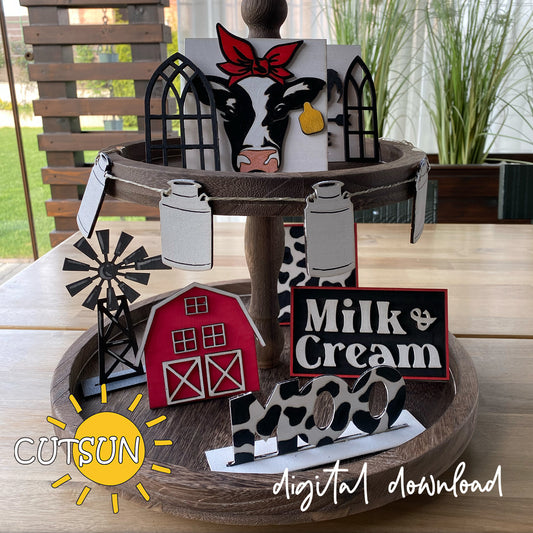 Decorative wooden tiered tray with farm-themed signs and a windmill on a wooden surface.