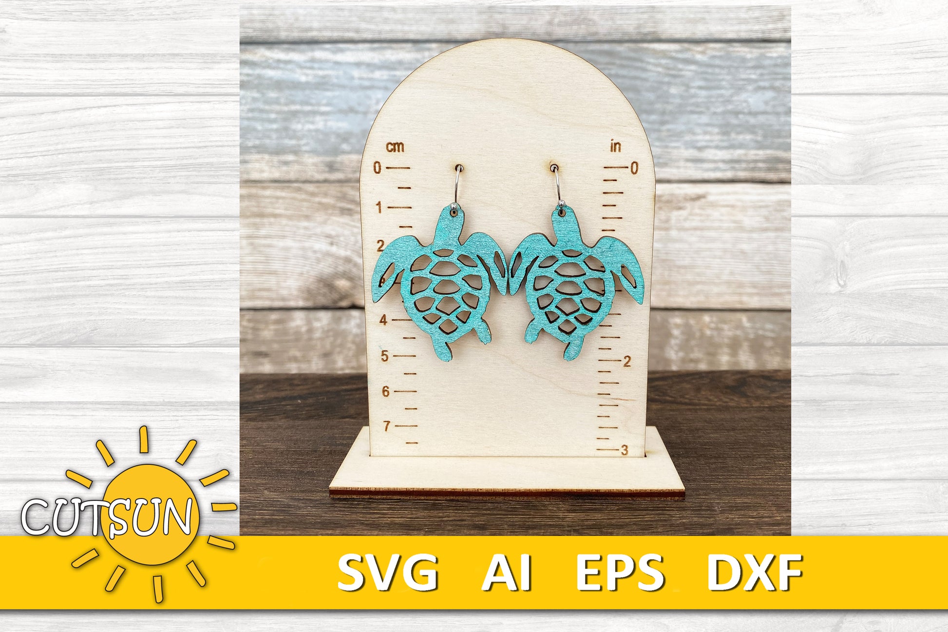 Pair of turquoise sea turtle earrings displayed on a wooden measurement stand, perfect for laser-cut jewelry crafts.