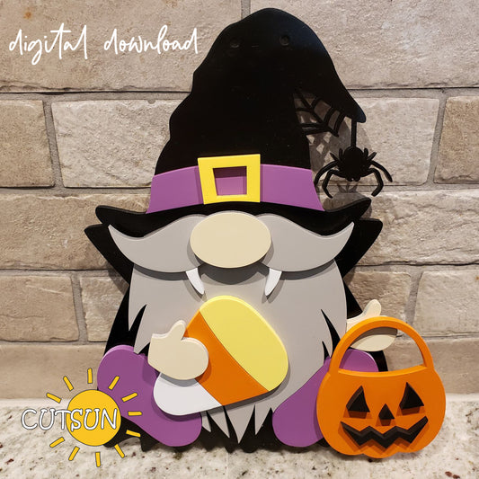 A digital download of a Halloween-themed gnome door hanger, featuring a vampire gnome with a candy corn and a Jack O'lantern. The gnome is dressed in a black and purple costume with a black hat, holding a pumpkin, and there is a spider on the web in the background.