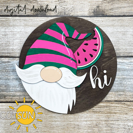 A digital illustration of a round door hanger featuring a green and pink striped gnome's hat with a slice of watermelon, and the text 'GNOME' and 'HI' on a wooden background.