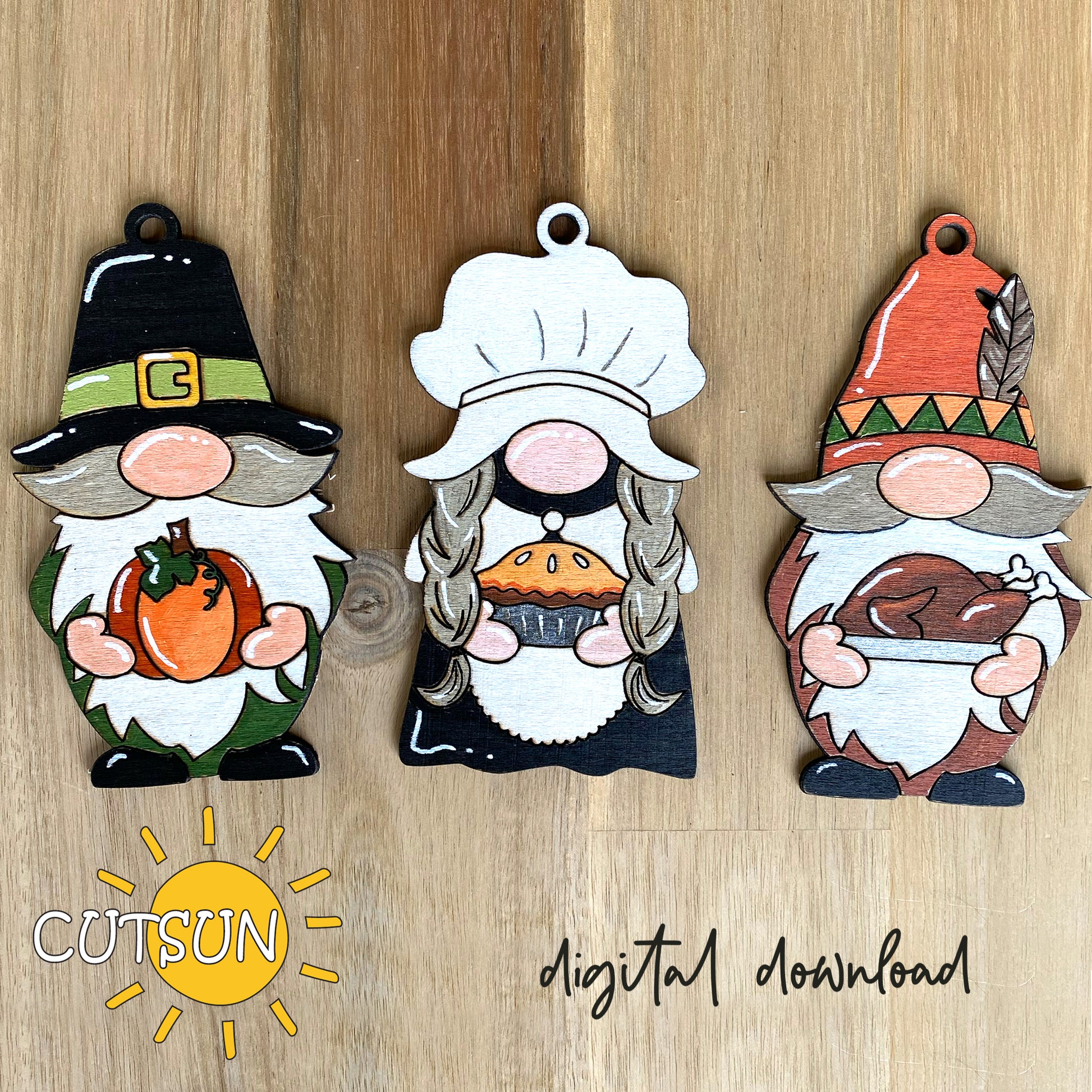 Three wooden gnome car charms with Thanksgiving themed decorations. Each gnome is painted with different colors, one holding a pumpkin pie, one with a pumpkin, and one with a turkey.