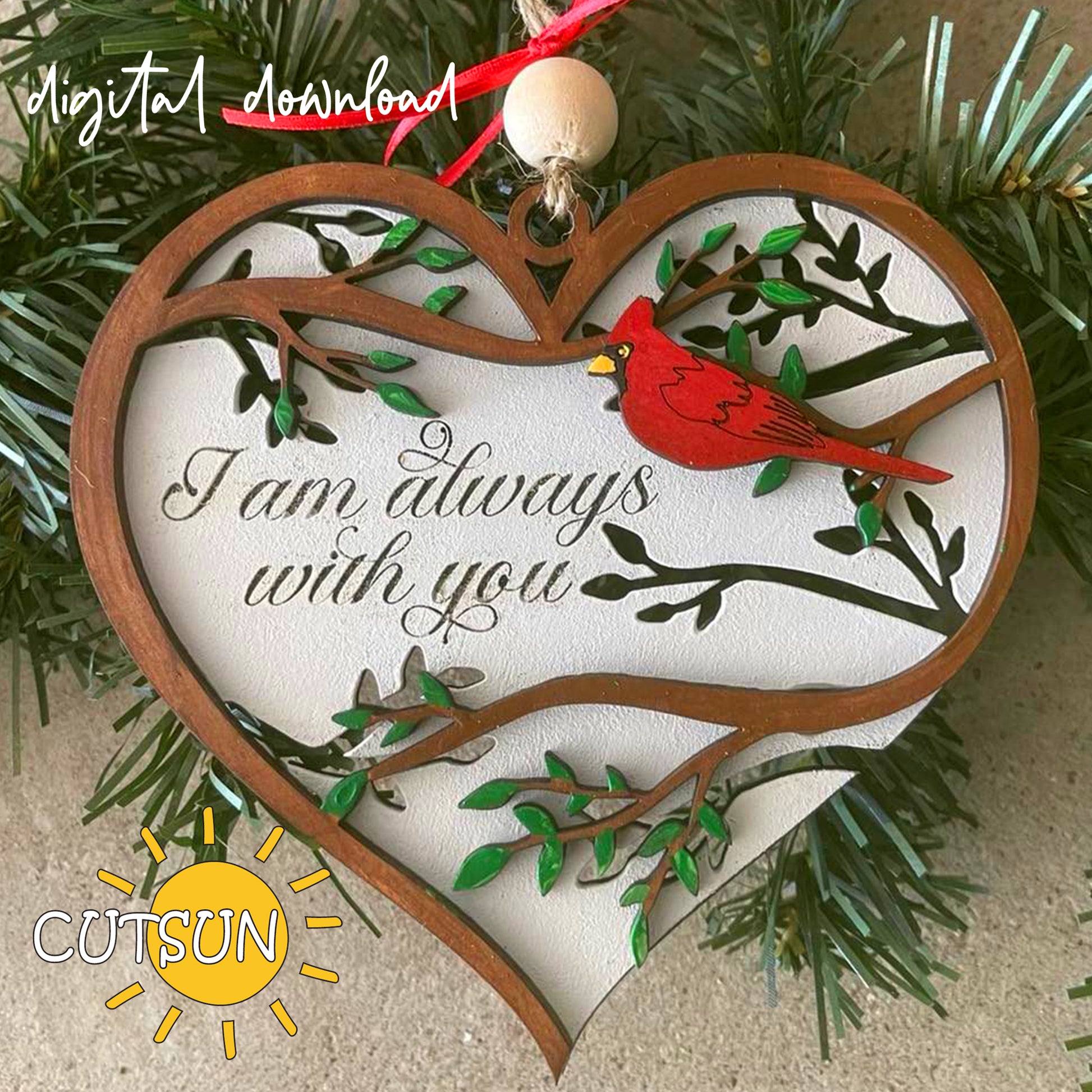 A digital image of a memorial ornament featuring a heart shape with a red bird and green branches on the front, and the text 'I am always with you' on the back layer.