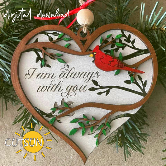 A digital image of a memorial ornament featuring a heart shape with a red bird and green branches on the front, and the text 'I am always with you' on the back layer.
