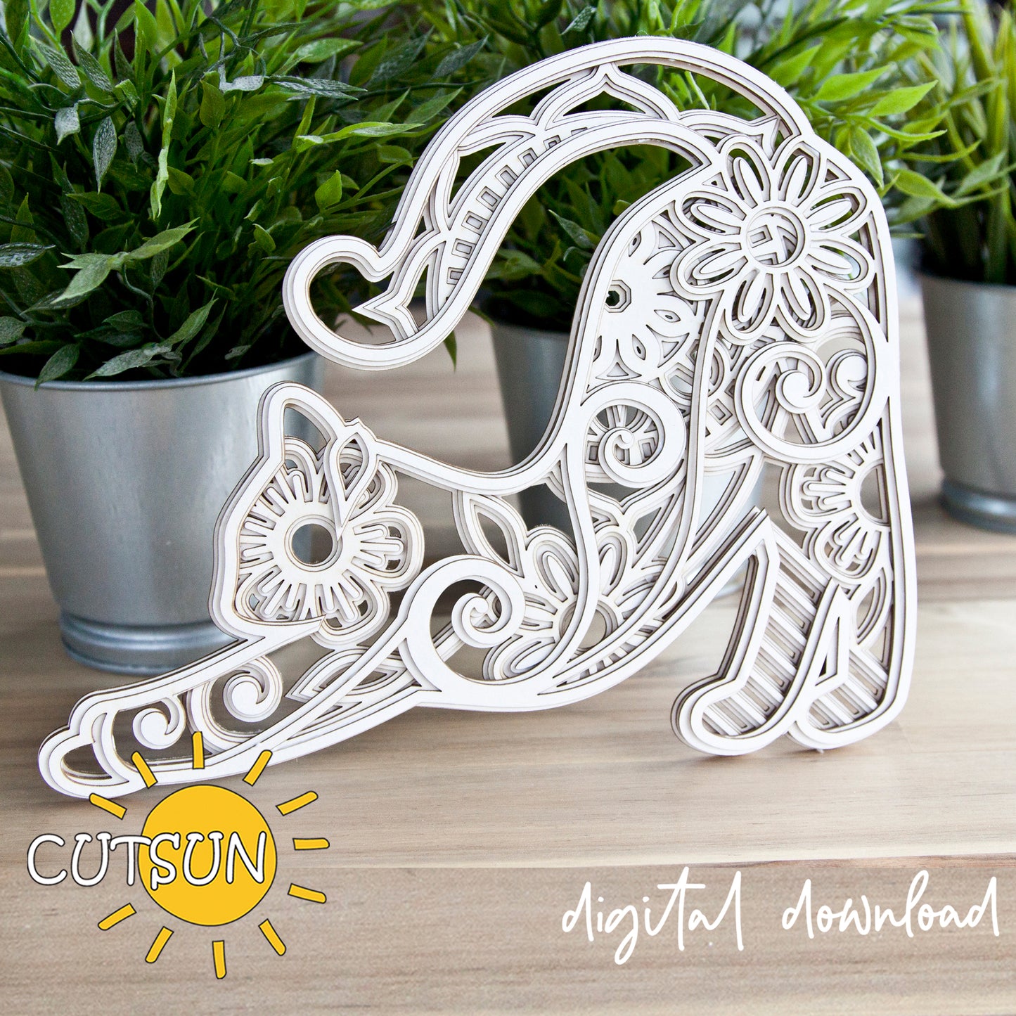 Decorative letter 'A' with intricate patterns on a wooden surface, surrounded by potted plants.