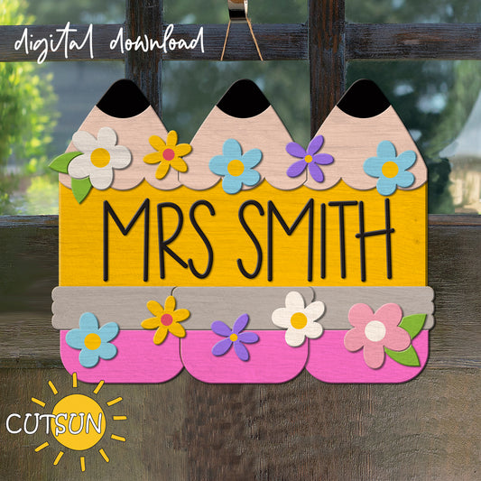 A digital door hanger with three pencils and floral elements, with the text 'MRS SMITH' in bold letters.