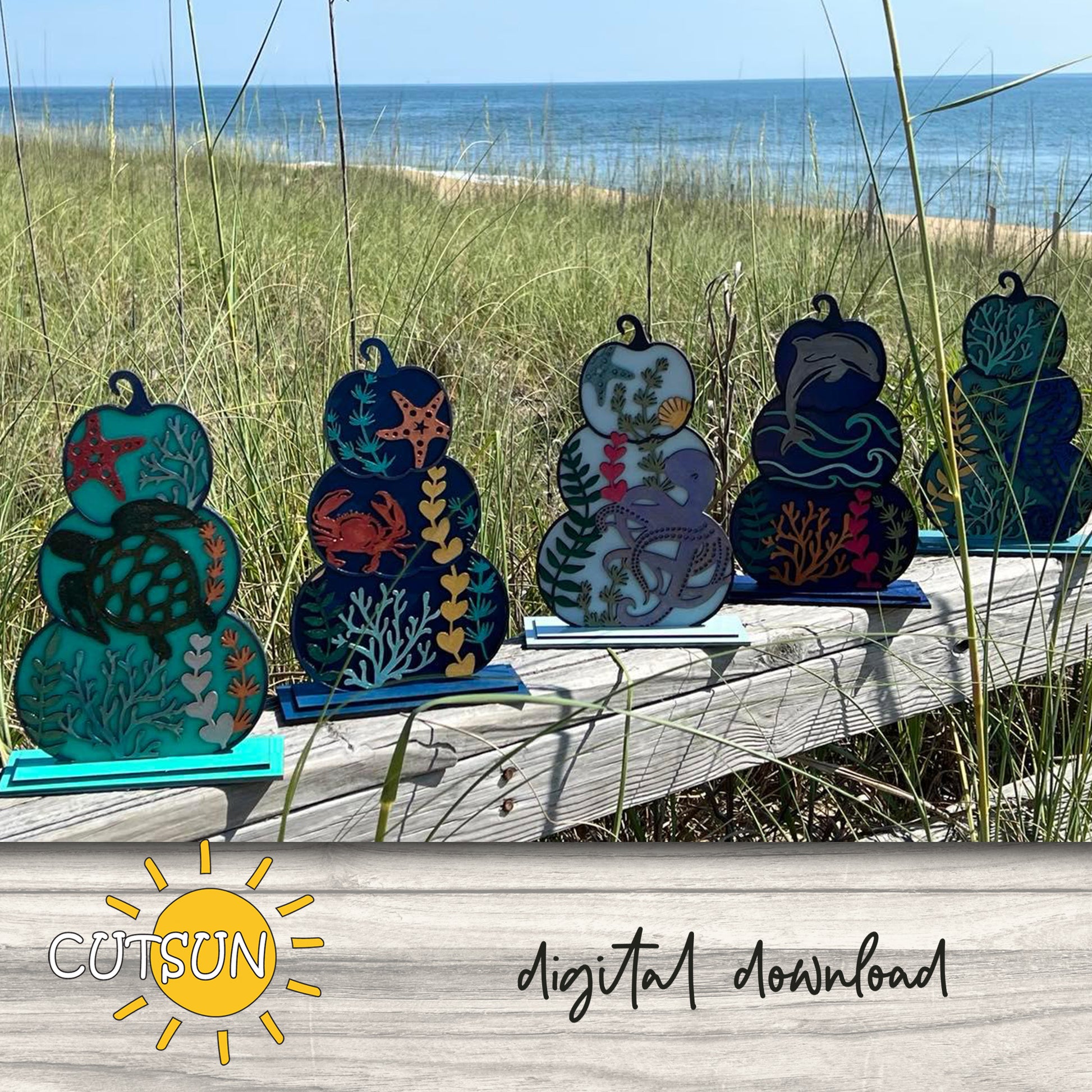 A set of six patterned pumpkins with sea life motifs, displayed on a wooden surface with a blurred background.