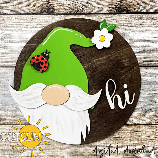 A digital illustration of a round gnome door hanger with a green body, white beard, and a flower and ladybug on it. The text 'H I' is also present on the gnome's hat.