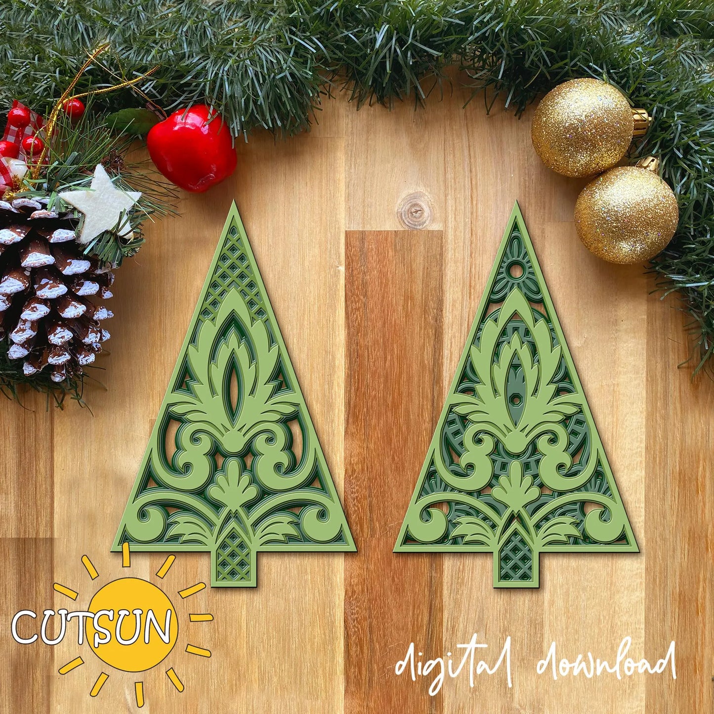 Decorative green Christmas tree cutouts on a wooden surface with festive decorations.