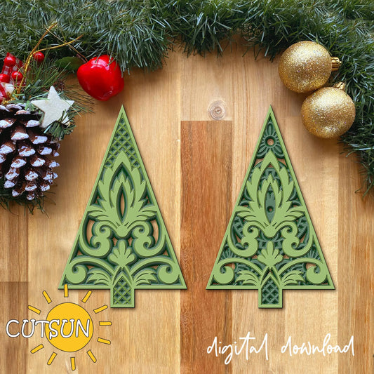 Decorative green Christmas tree cutouts on a wooden surface with festive decorations.