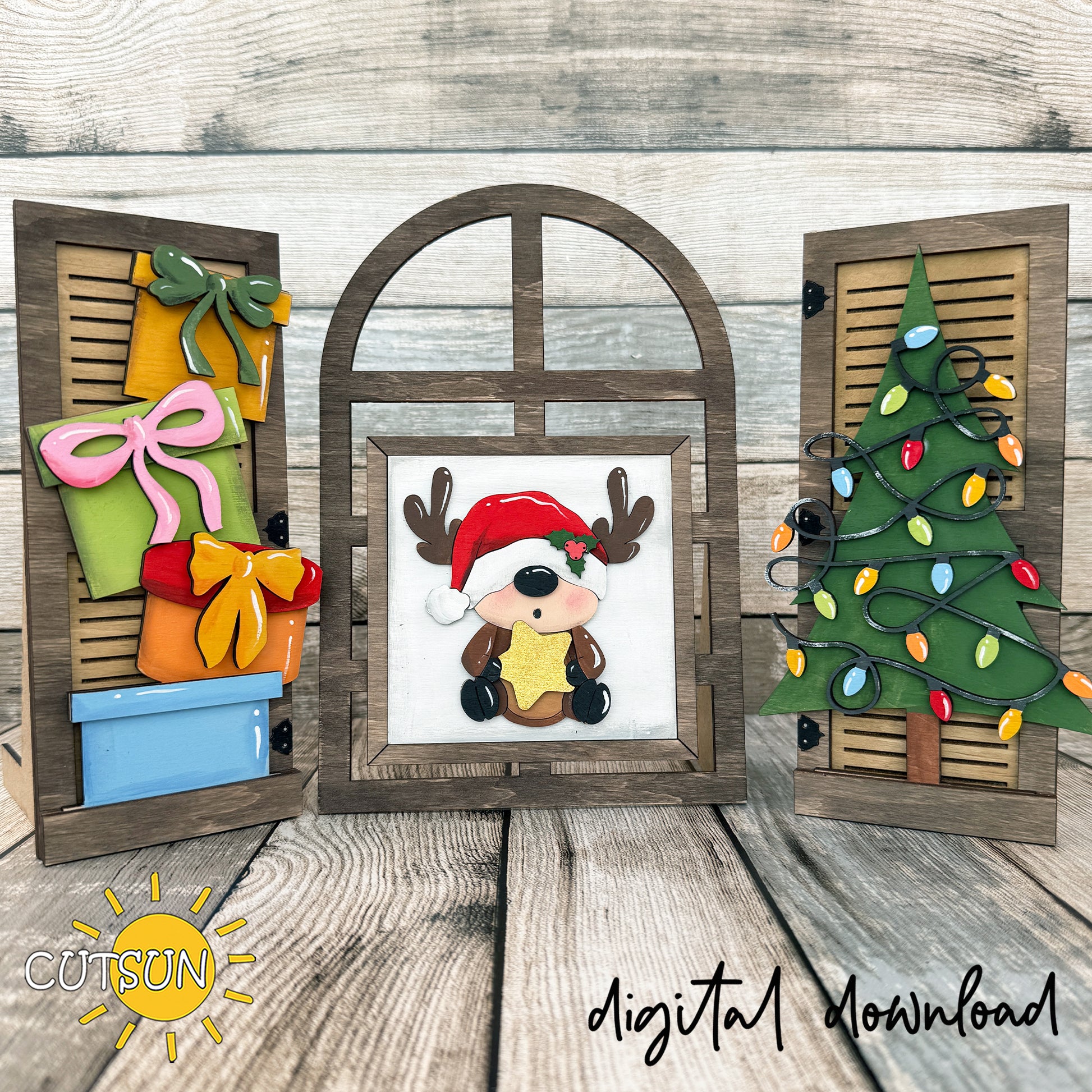 Interchangeable wooden farmhouse window decorated with a baby reindeer, colorful Christmas presents and a tree covered in holiday lights.