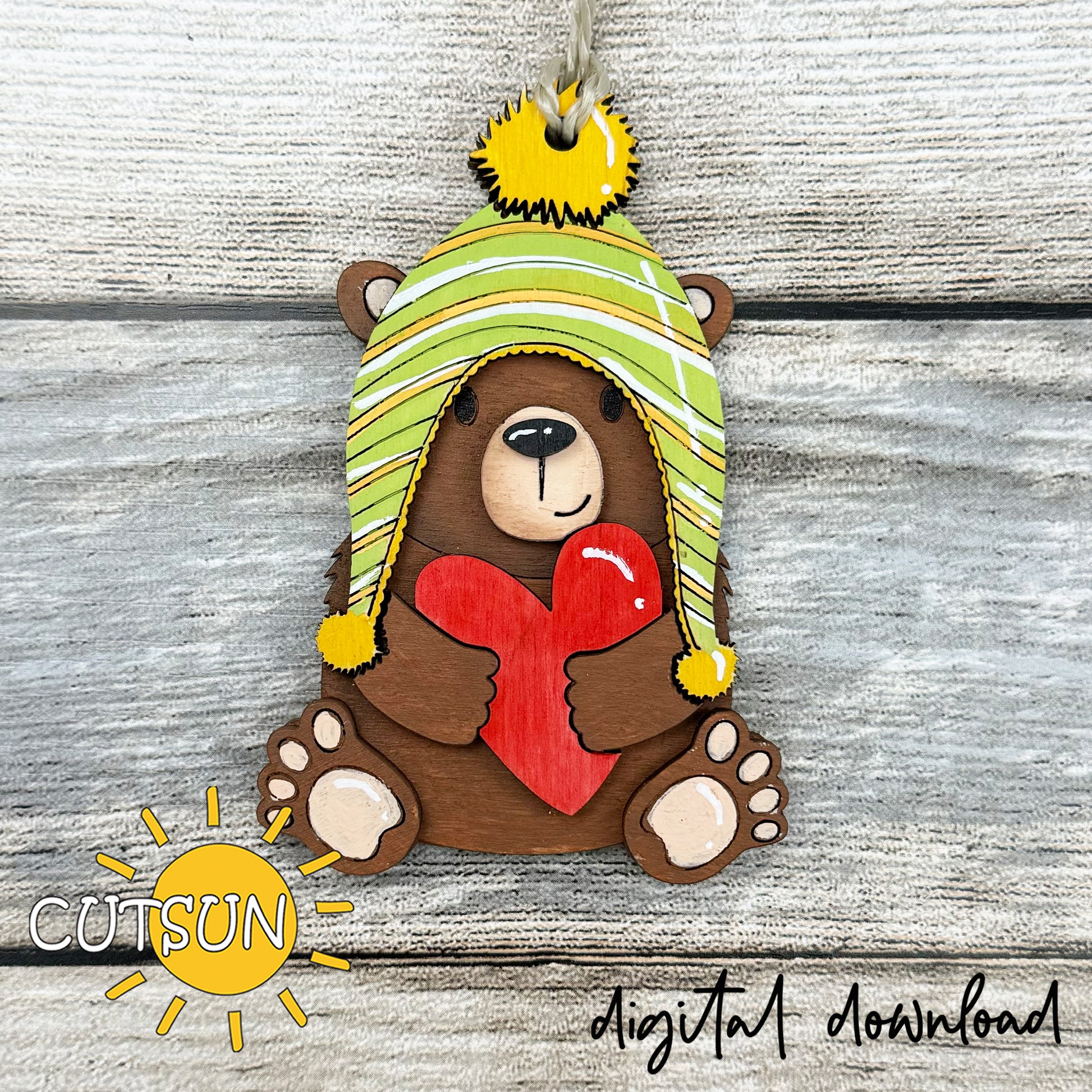 Layered bear with heart ornament SVG file for laser cutting, featuring a winter hat and red heart, perfect for Valentine’s crafts and gifts.