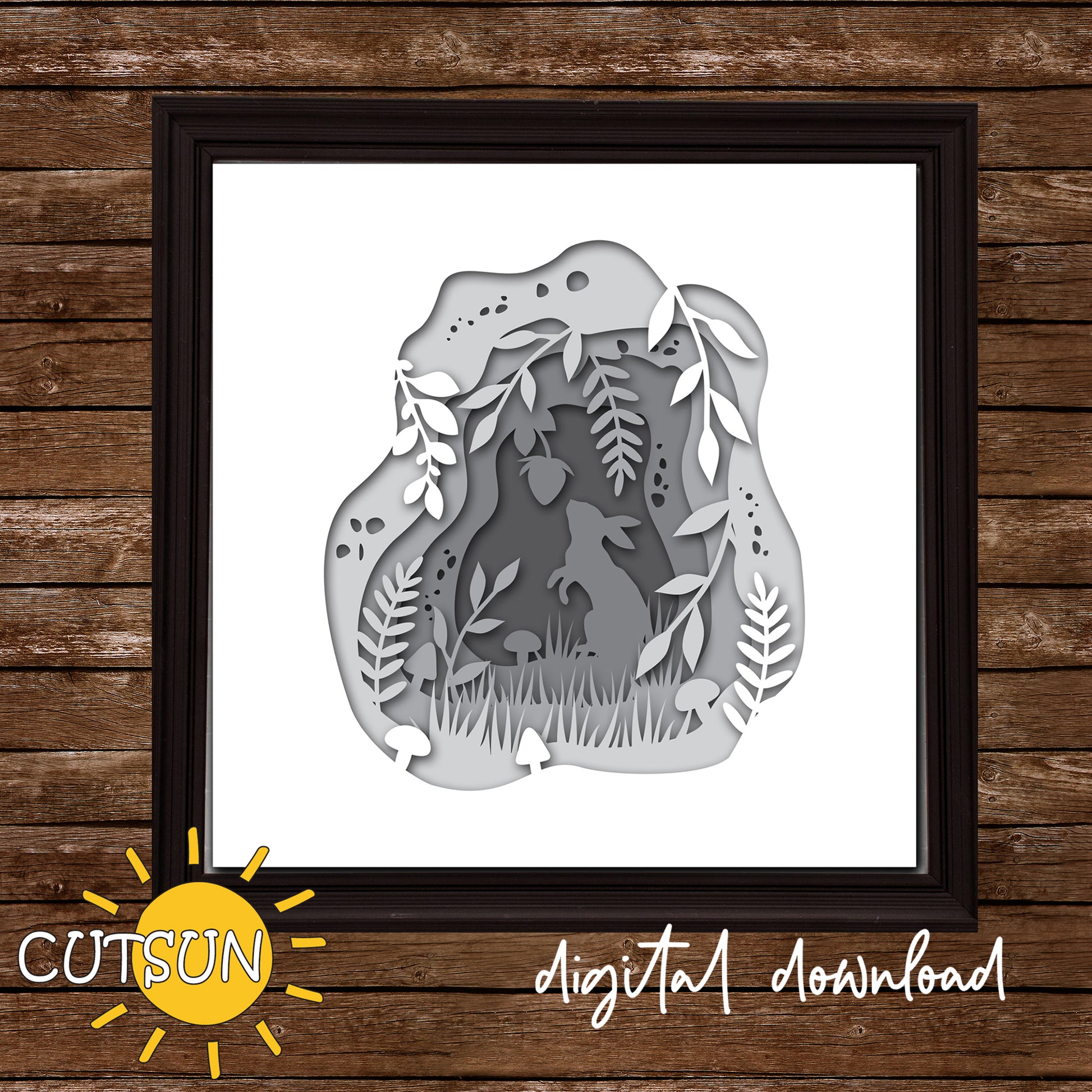 Framed paper cut art of a rabbit in a forest design on a wooden background with 'CUTSUN' branding.