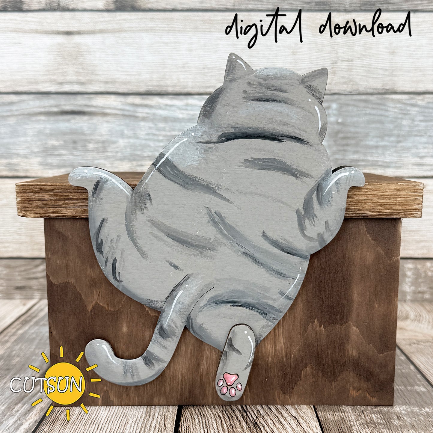 Layered wooden climbing cat shelf sitter hanging over edge with visible paws and tail, funny laser cut cat decor design