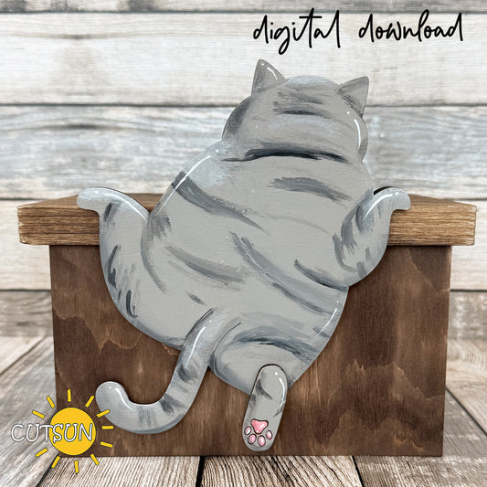 Layered wooden climbing cat shelf sitter hanging over edge with visible paws and tail, funny laser cut cat decor design