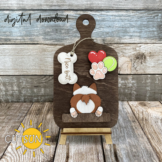 A digital download image showing a wooden cutting board with a corgi silhouette, heart, tennis ball, and paw print decorations.