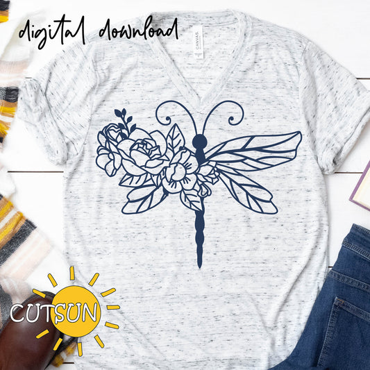 White t-shirt with a black dragonfly and flower design, placed on a wooden surface with 'CUTSUN' logo.