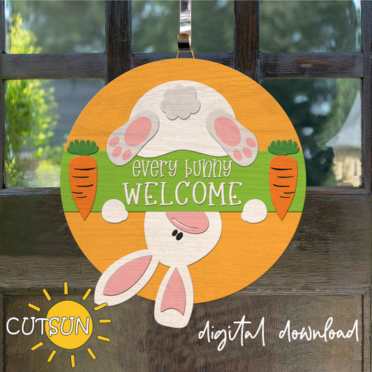 Decorative door hanger with bunny design and 'Every Bunny Welcome' text on a wooden background.
