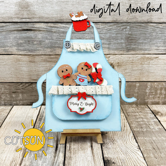 Layered Gingerbread Apron Add-On SVG featuring gingerbread cookies, candy cane, hot cocoa mug and Merry & Bright tag for Christmas apron displays.