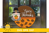 SVG digital download for a round door hanger with a gnome holding a pumpkin, a patterned bottom part with fall leaves and the words Give thanks in a playful script font