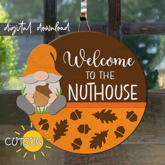 A digital door hanger featuring a gnome with an acorn, and the text 'Welcome to the NUTHOUSE' on a round orange background with leaf patterns.